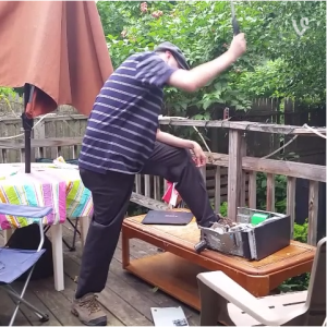 Tom hitting PC with hammer